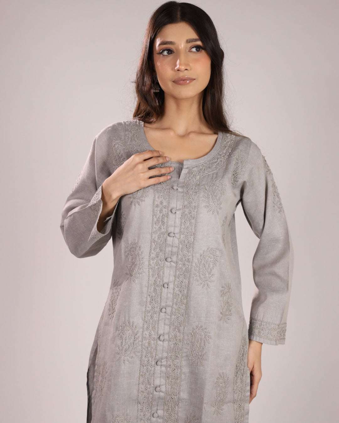 Women wearing a grey cotton chikan kurta with a plain background