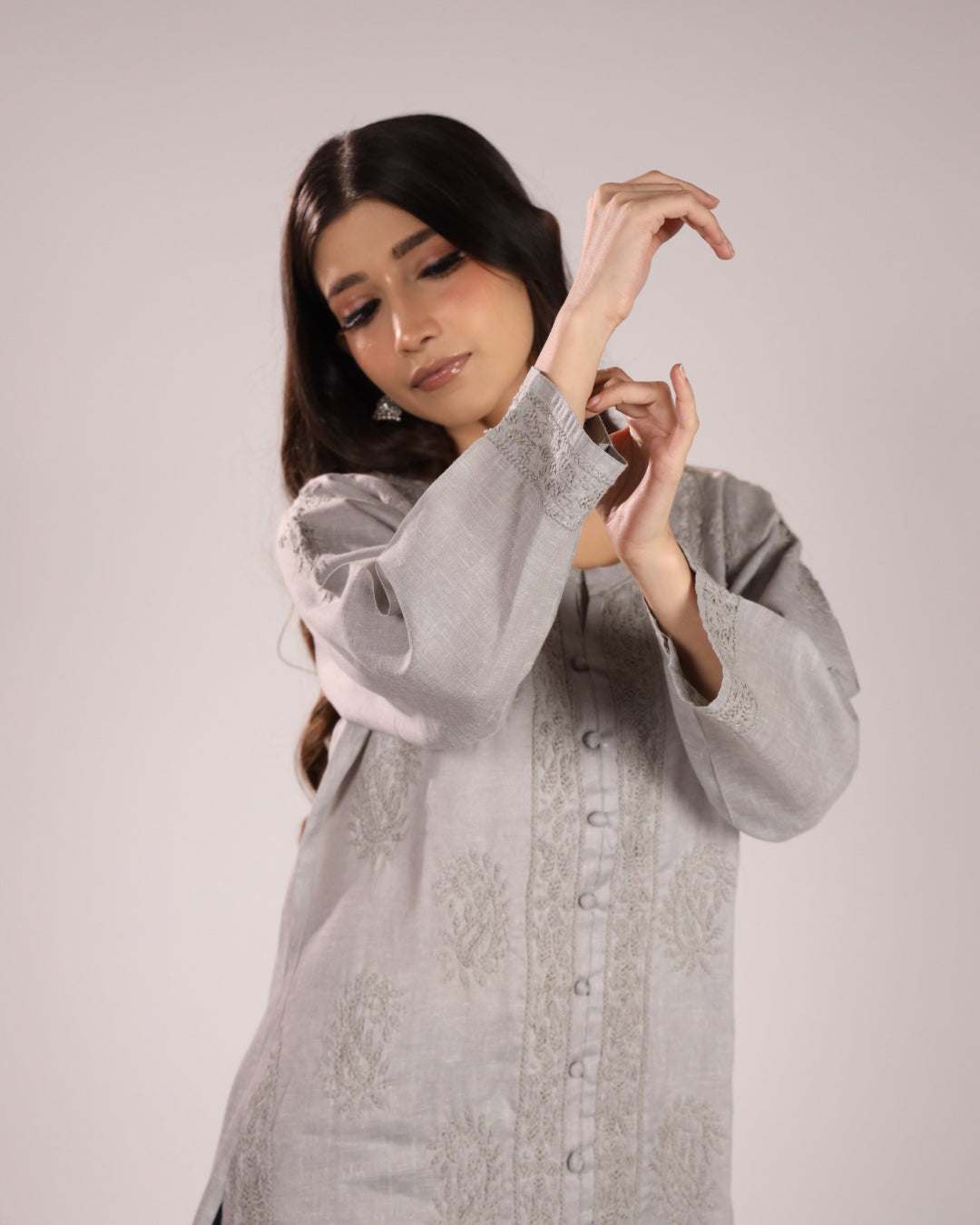 Women wearing a grey cotton chikan kurta with a plain background