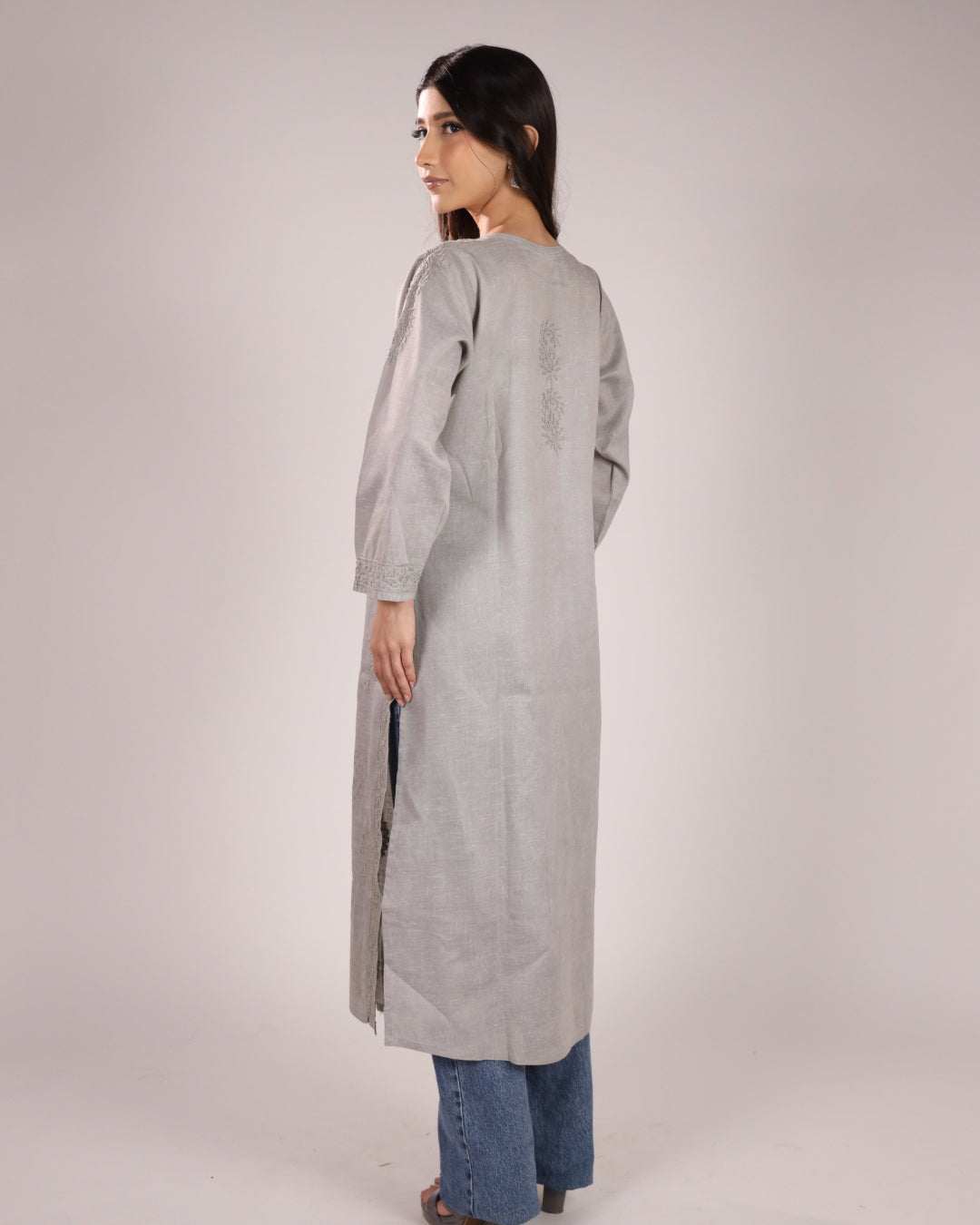 back view of grey cotton chikan kurta with a plain background