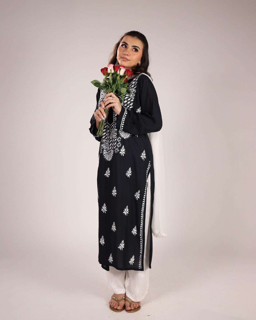 Woman wearing a Chikankari Black Kurta Set on a plain background