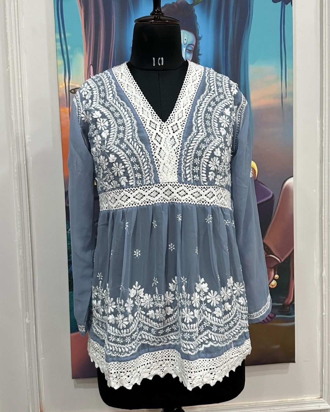 Woman wearing georgette grey chikankari short kurta with full sleeves and lace embroidery