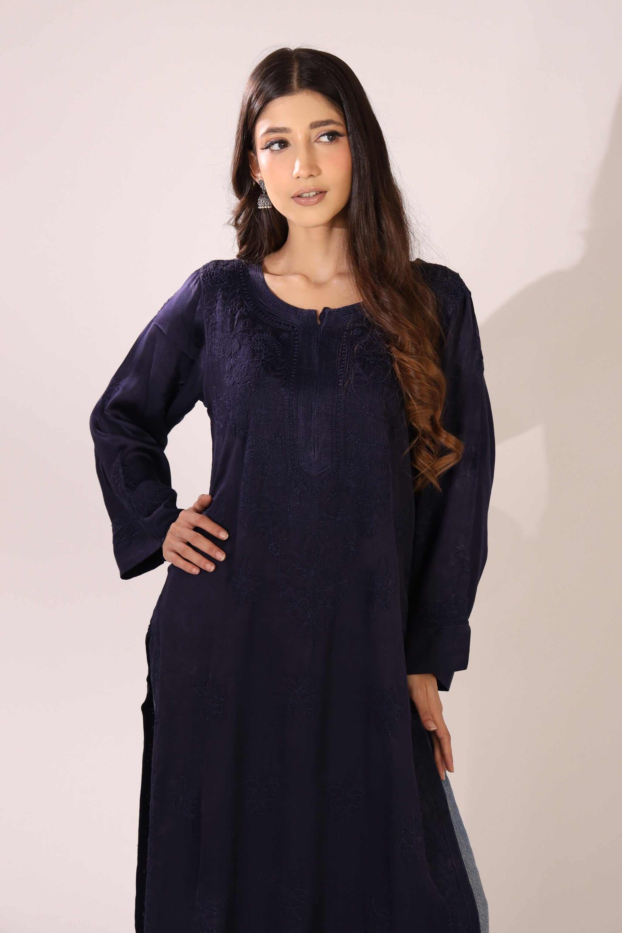 Woman wearing a dark blue lucknowi kurti against a white background