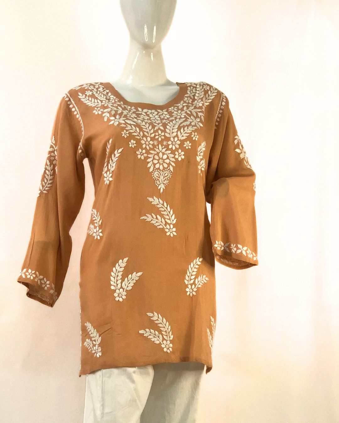 Brown Chikankari short kurta for women in modal cotton fabric styled with jeans