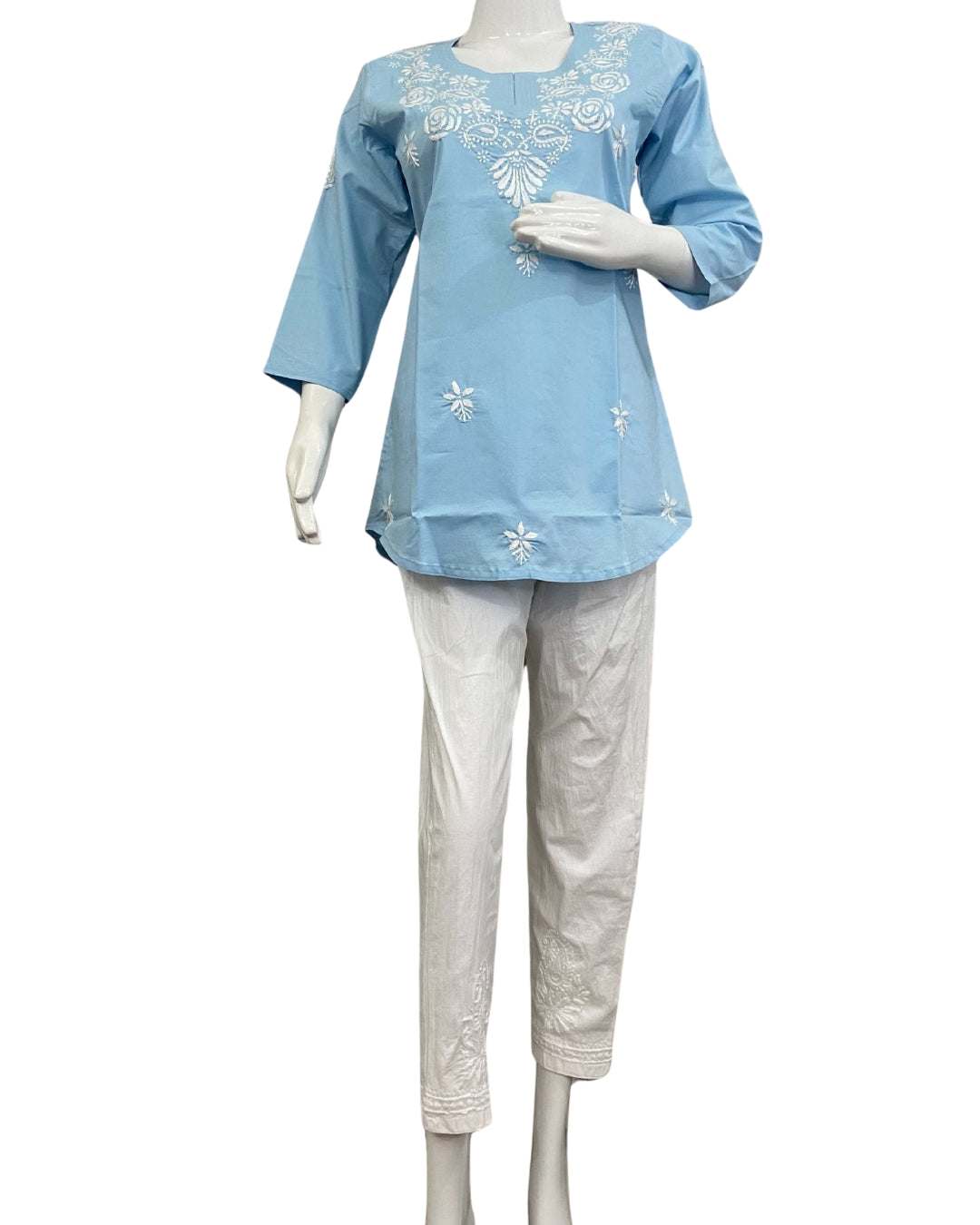 Women wearing sky blue chikankari short kurti with white embroidery, made of lycra cotton