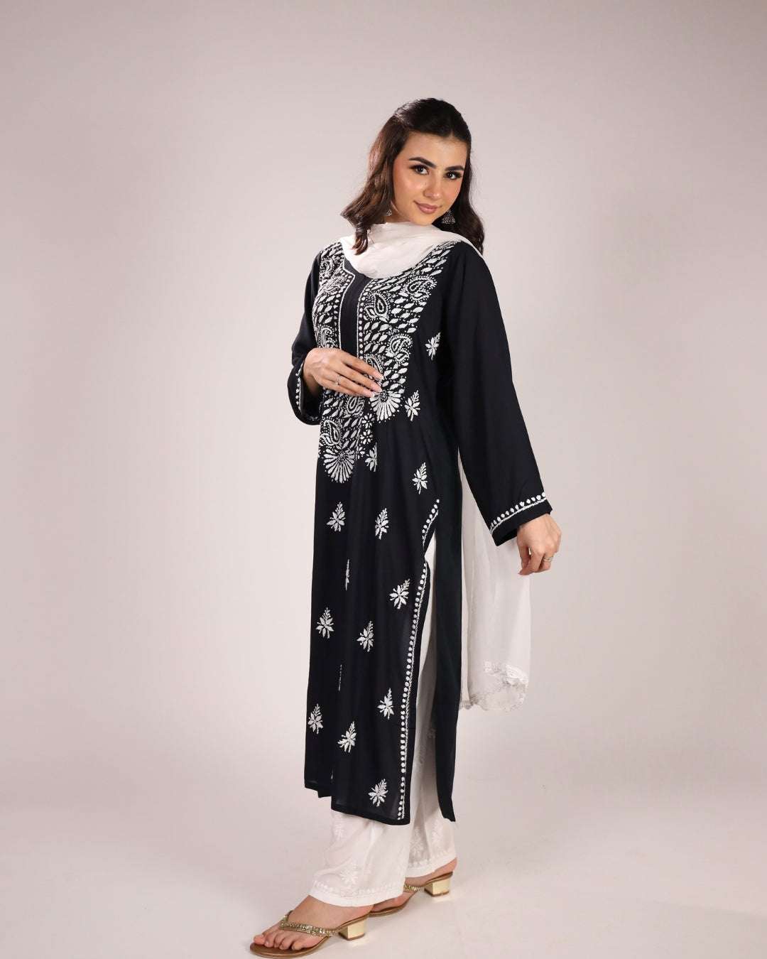 women wearing a chikankari black kurta set with dupatta in the white back ground