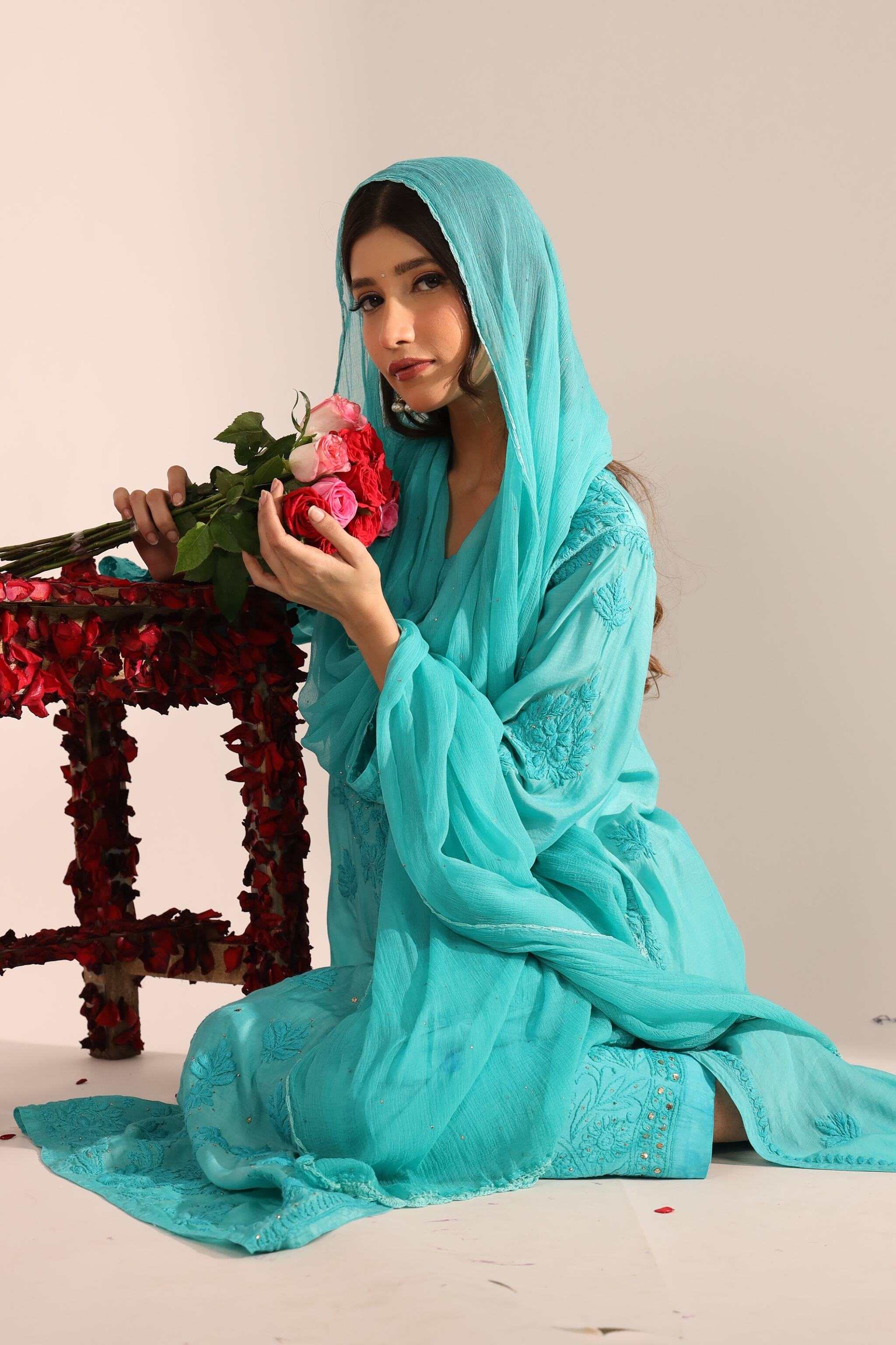 Front view of model wearing sea green Sitara Mayra Kurta Set with dupatta and palazzo pants. sitting on the floor