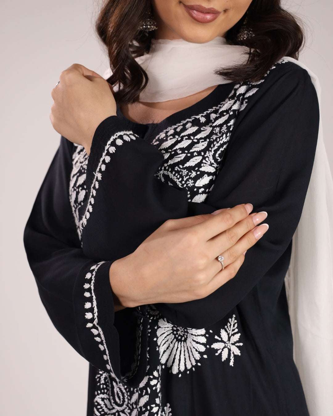close up view of Chikankari black kurta set with dupatta with white pants on a plain background