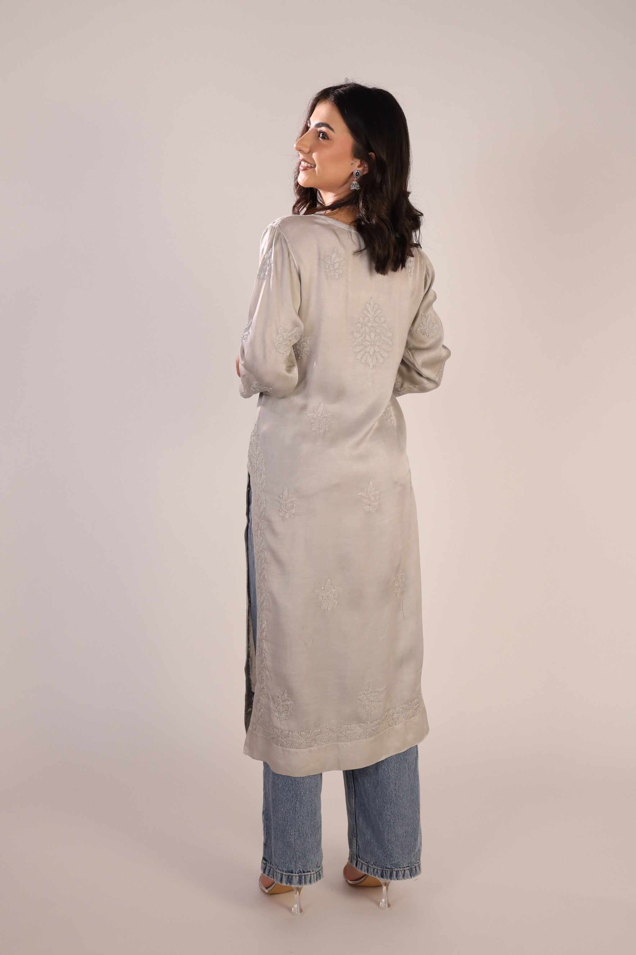 Back view of women's chikankari kurta in pastel grey colour showcasing detailed lucknowi embroidery and straight-fit silhouette.
