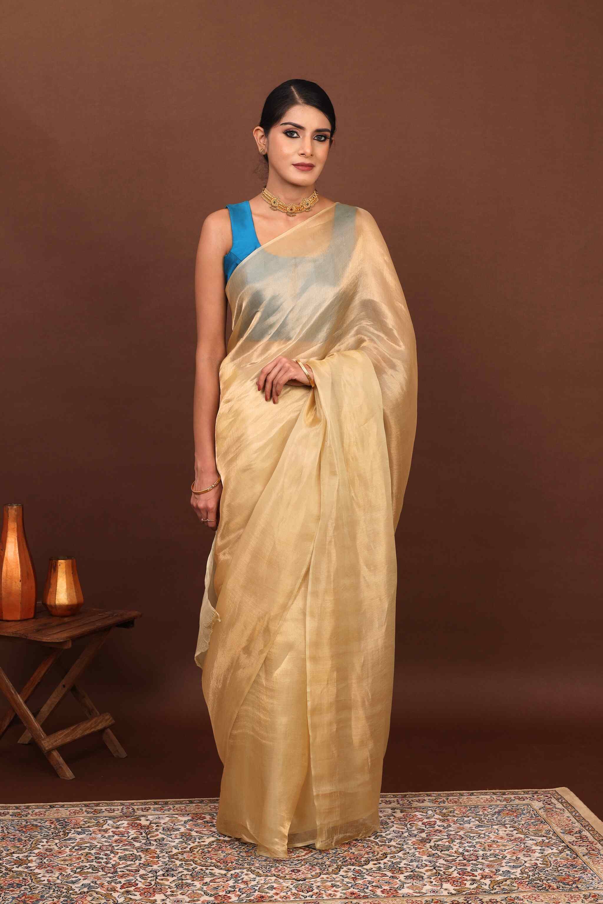 In front view model posing elegantly in goldem gleam banarasi tissue silk saree