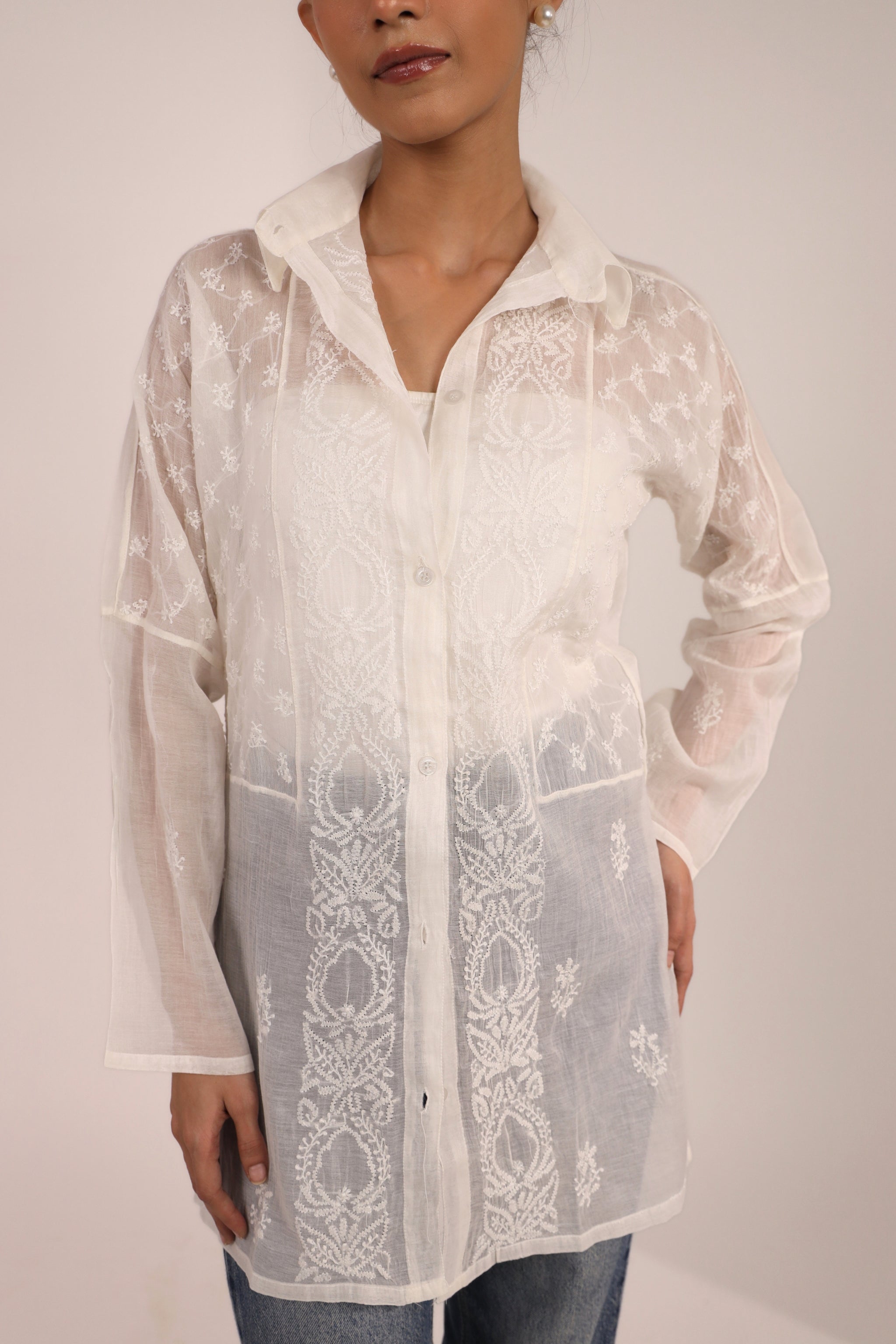 White Chikankari Short kurti for women worn by a woman on a plain background