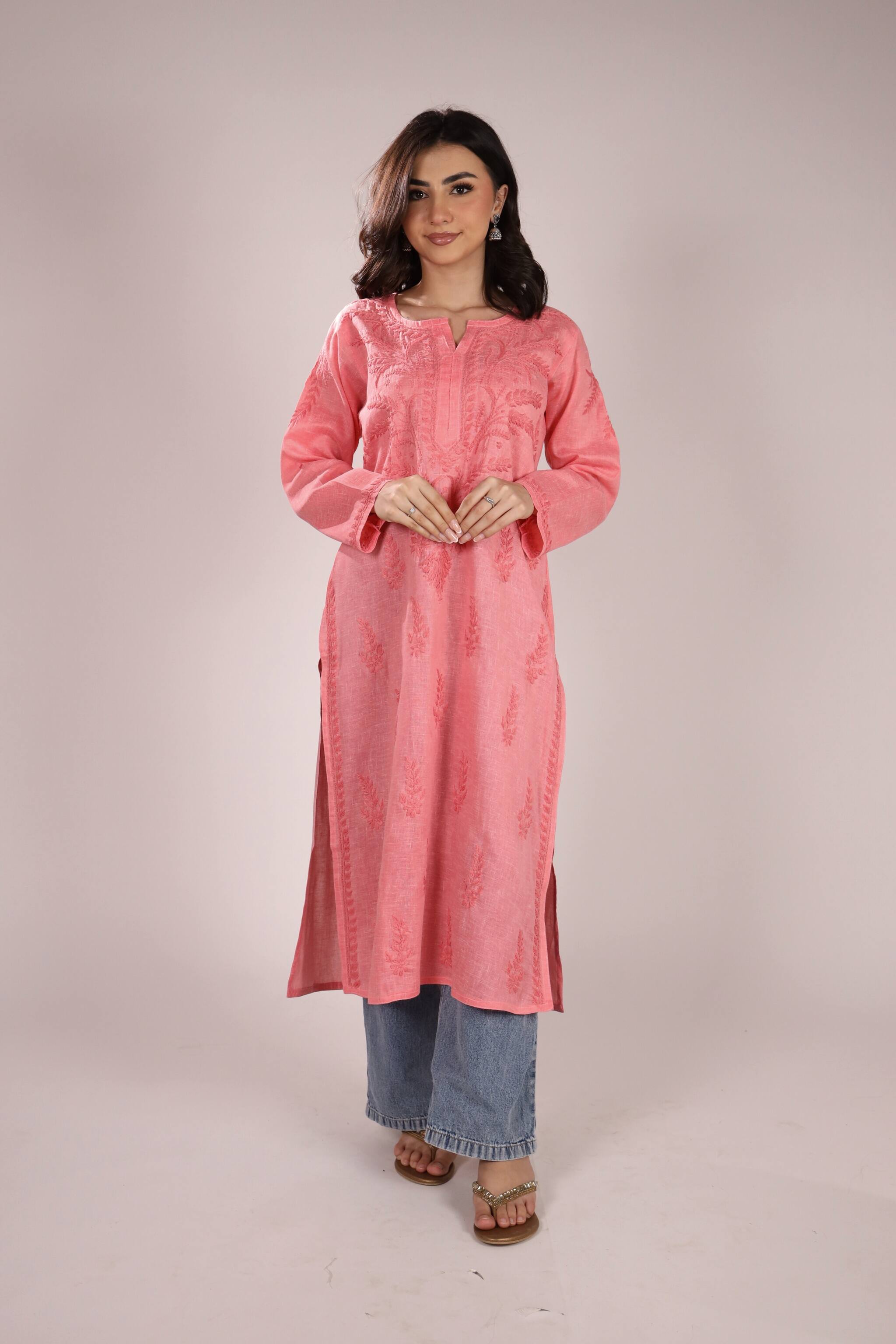 Woman wearing a Cotton Chikan Kurti For Women for Office Wear kurta with blue jeans on a plain background