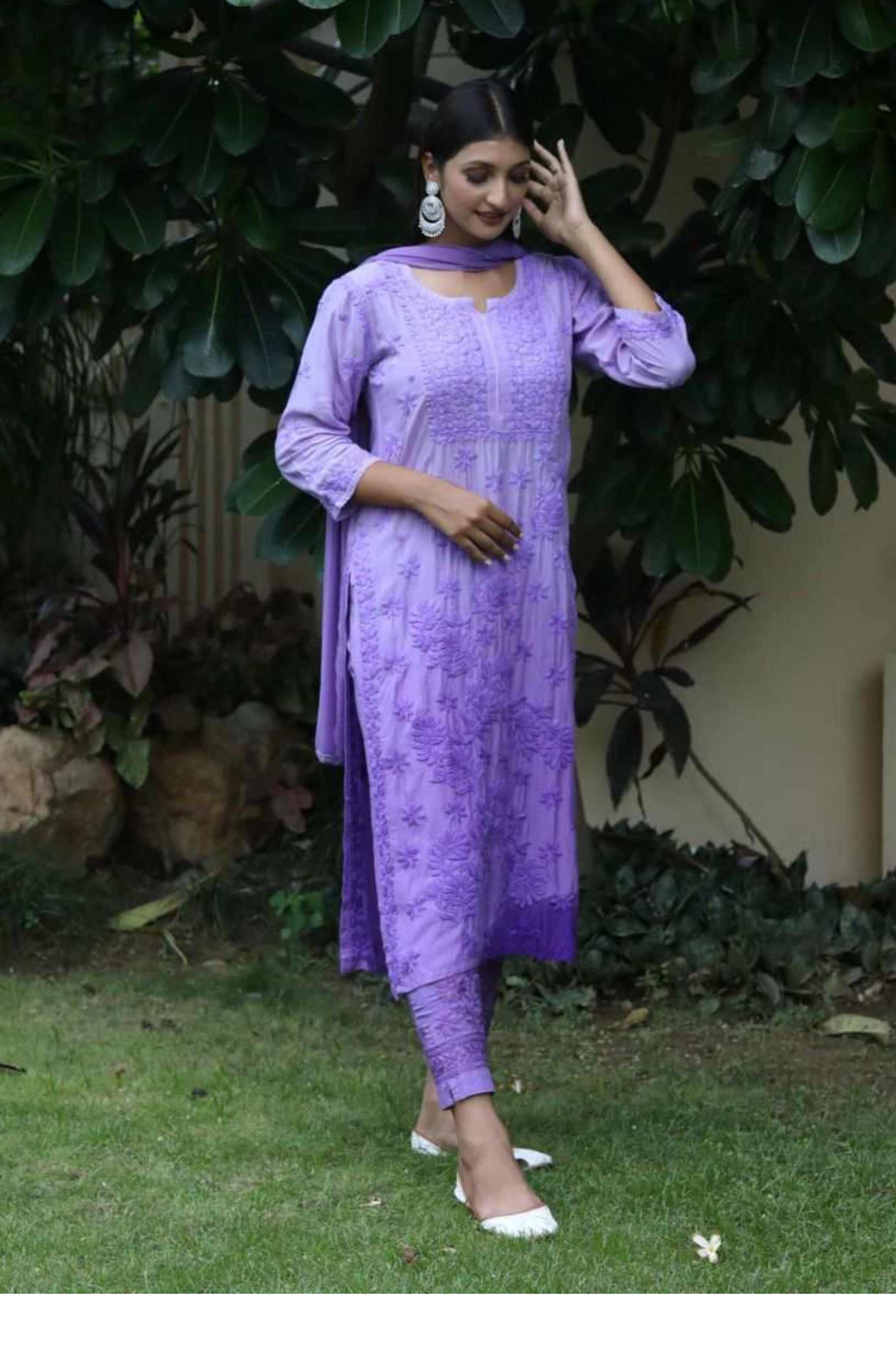 Woman in a purple Gauhar Purple Chikankari Suit For Women standing outdoors with greenery in the background