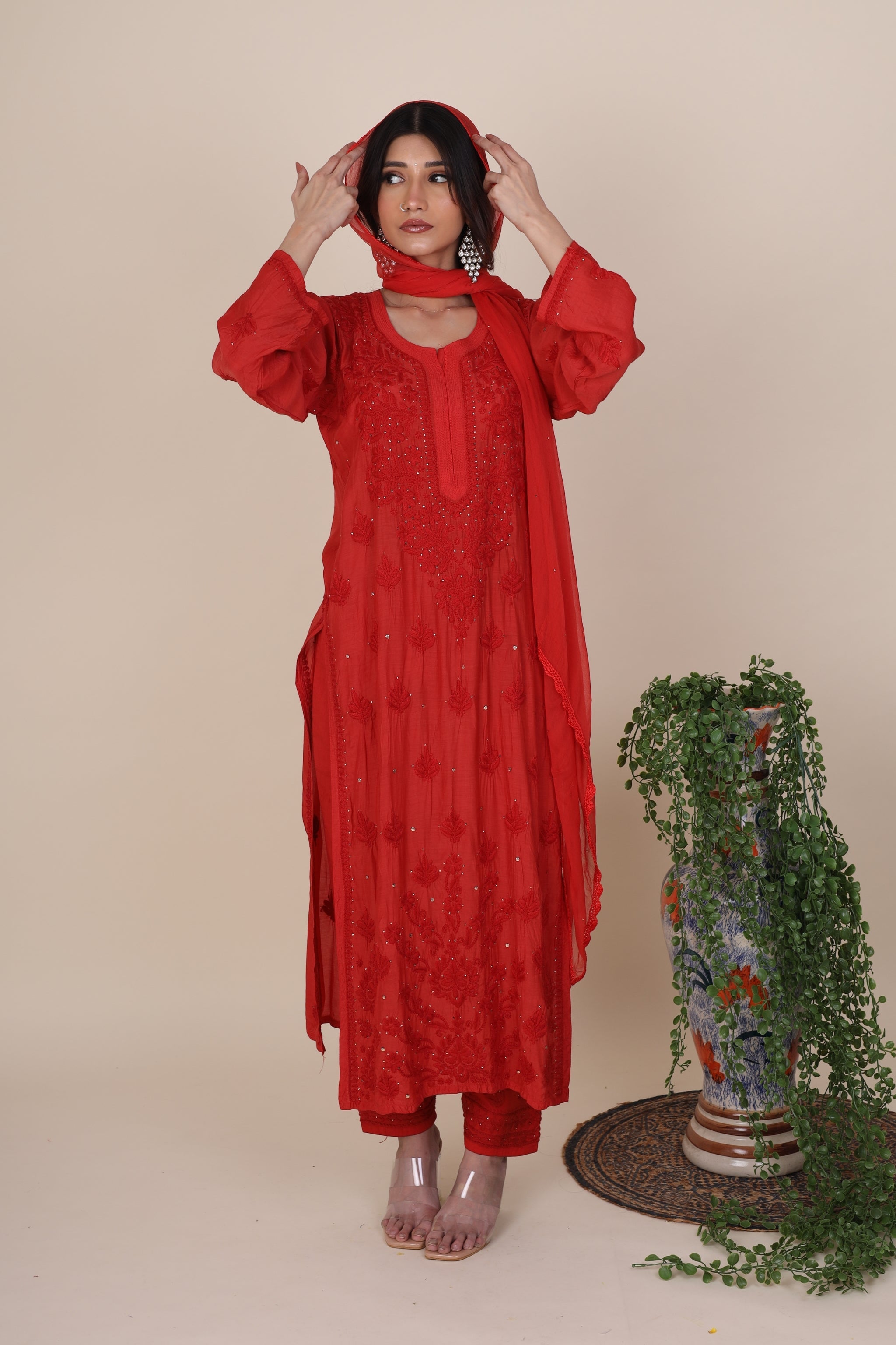 Woman wearing a red traditional Gulaabo Crimson Red Kurta Set For Women with a beige background