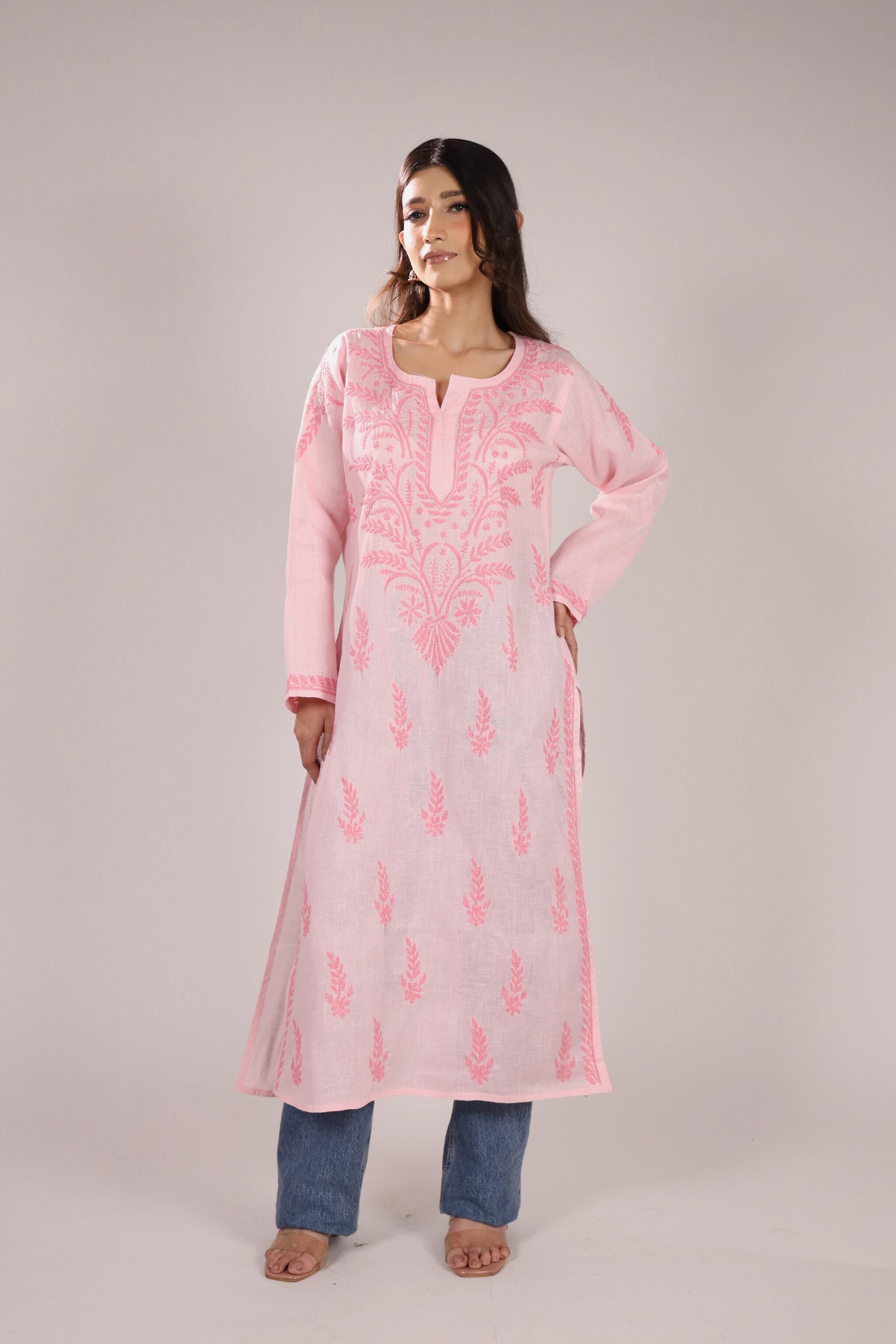 A women wearing a pink chikankari kurta with plain background