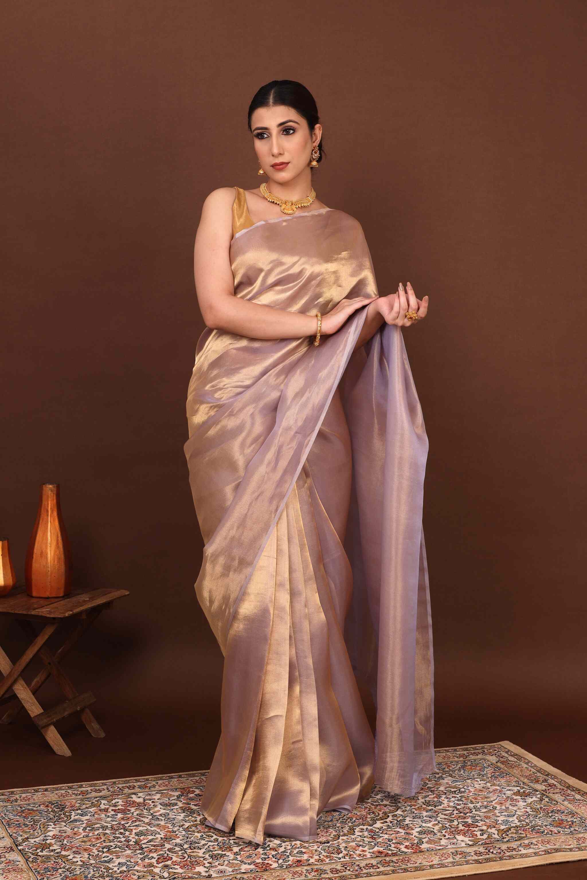 Front view model wearing a Banarasi pure tissue silk saree and elegantly posing