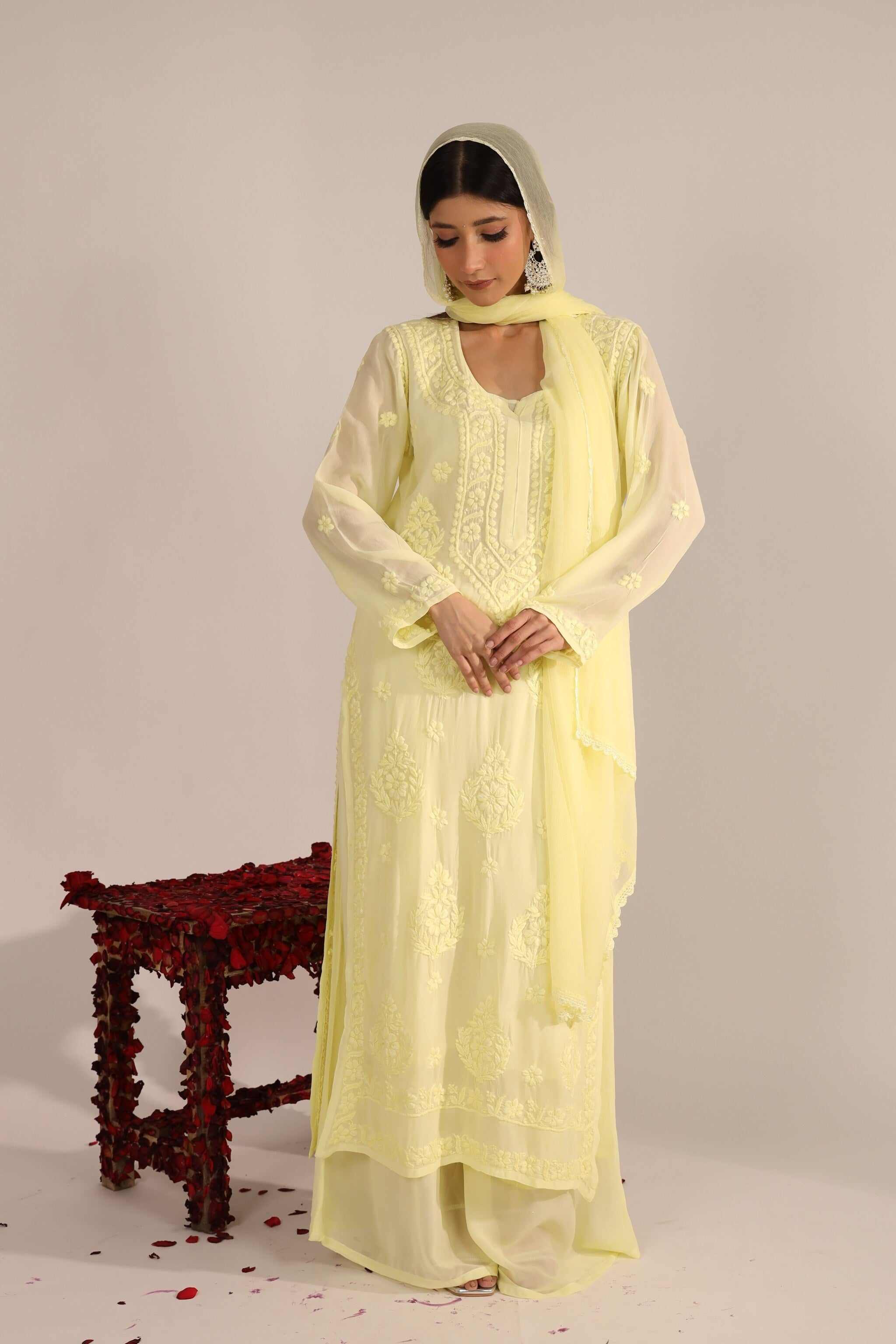 Front View: Woman wearing pastel yellow Georgette Chikankari suit with dupatta – front view.