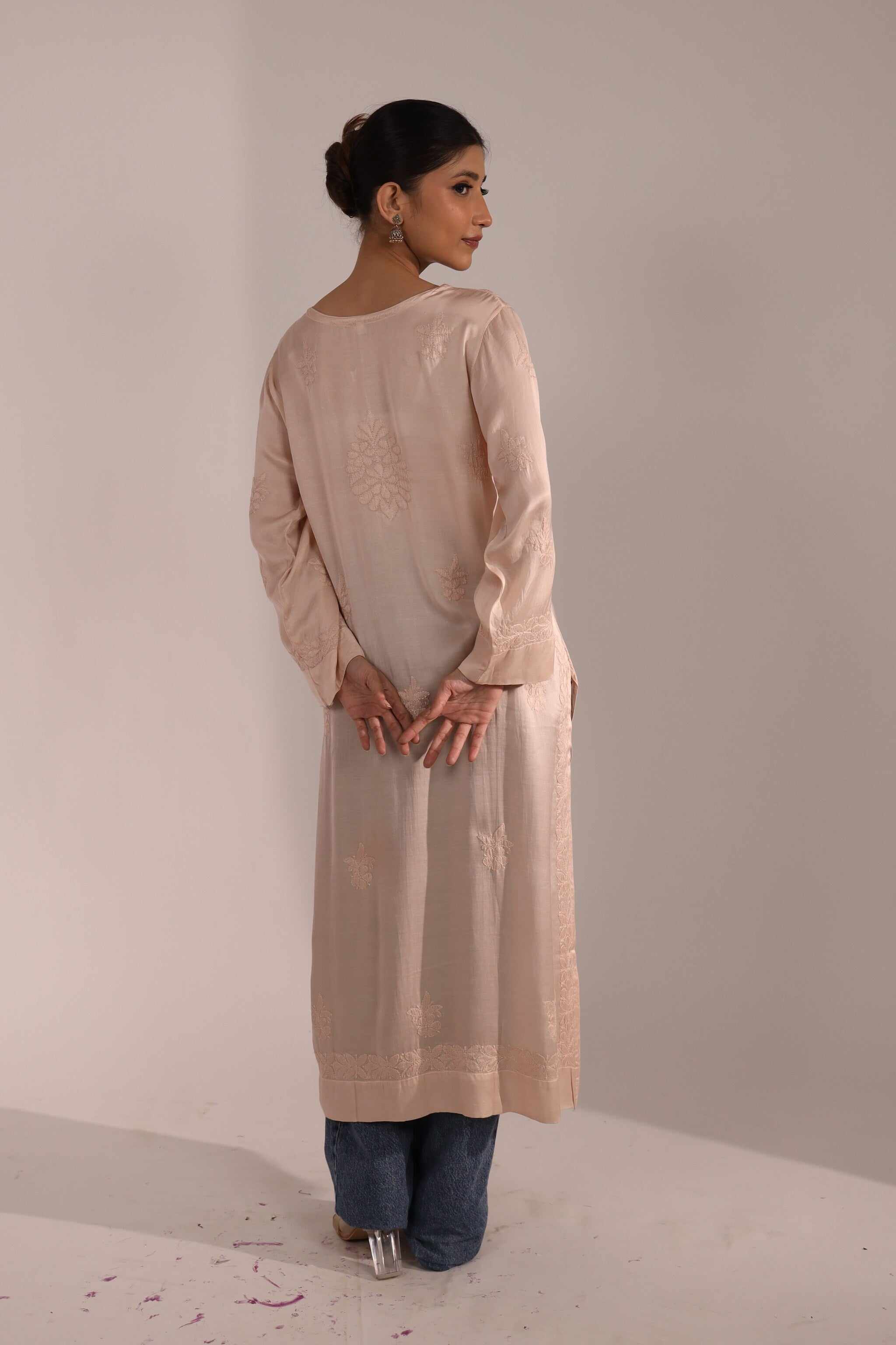 Back view of pastel pink Chikankari Kurti with fine detailing, paired with denim – fusion ethnic wear for modern women.

