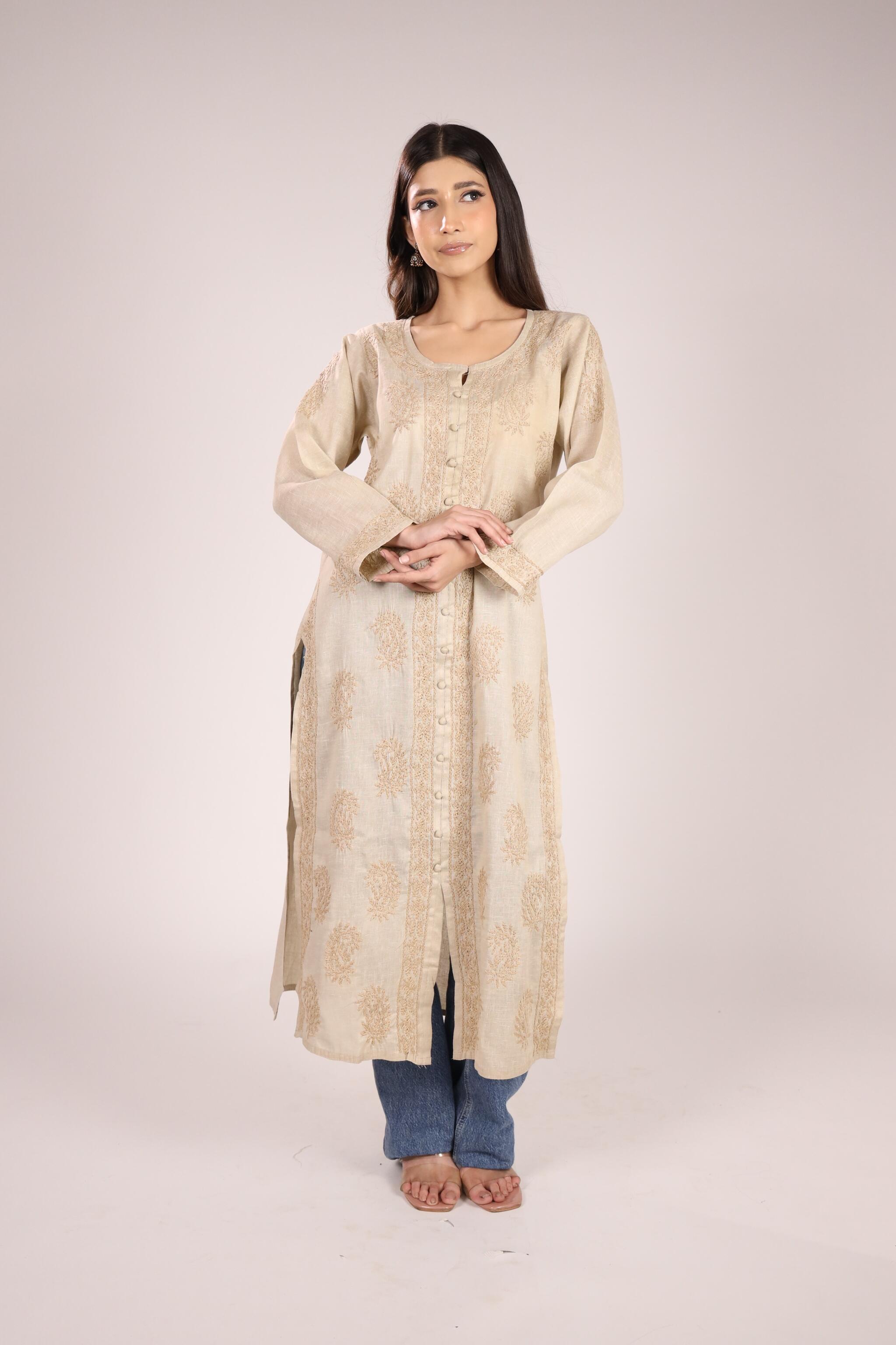 A women wearing a Ladies Chikankari kurta in soil brown colour with a plain backgound